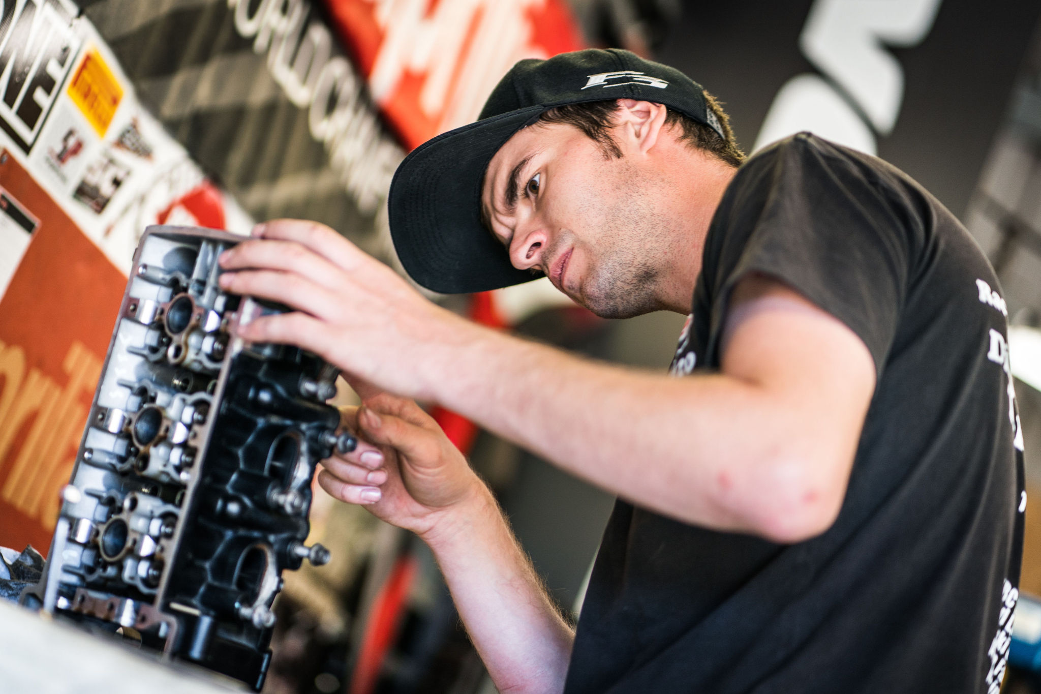 Mechanic inspecting a motorcycle engine assembly.